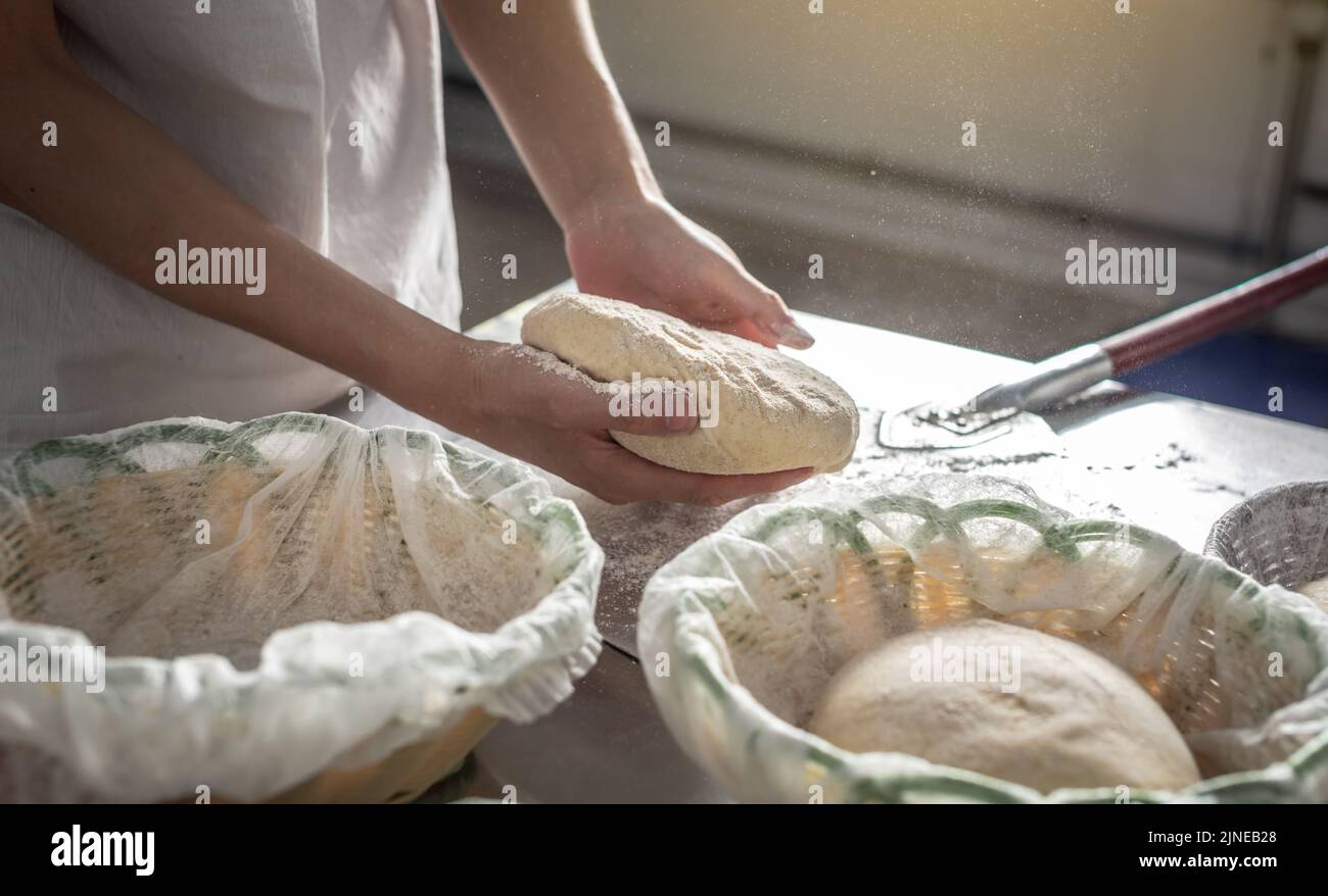The baker is a man in the process of baking bread. Production of bakery