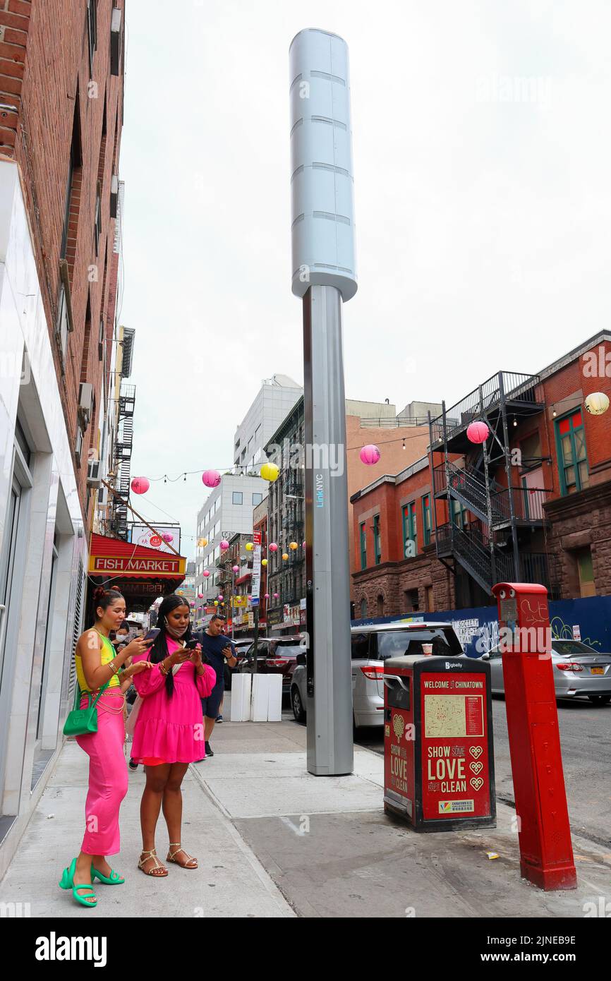 A LinkNYC Link5G 5G WiFi kiosk in Manhattan Chinatown, New York. The gigantic 32 foot smartpoles replace older LinkNYC 4G wi-fi kiosks under a new ... Stock Photo
