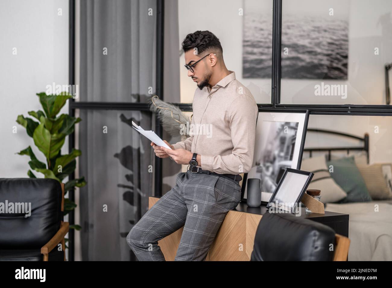 Man standing sideways to camera reading newspaper Stock Photo