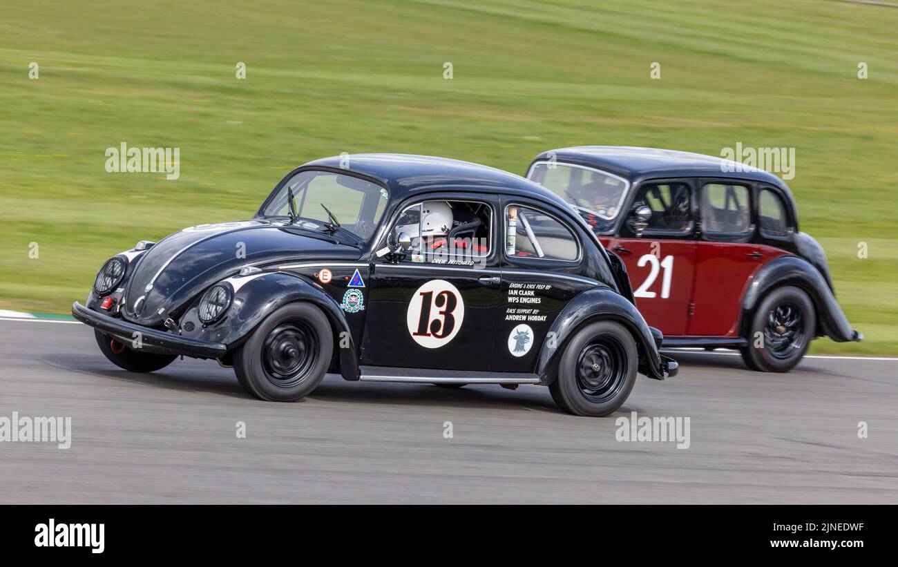1958 Volkswagen Beetle with driver Drew Pritchard passes Colburn's MG during the Sopwith Cup race at the Goodwood 79th Members Meeting, Sussex, UK. Stock Photo