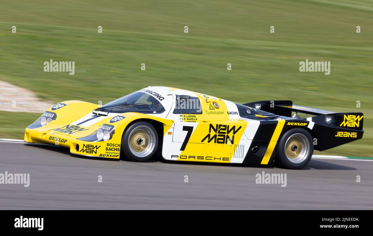 1984 Porsche 956B endurance racer with driver Klaus Ludwig at the Goodwood 79th Members Meeting, Sussex, UK. Stock Photo