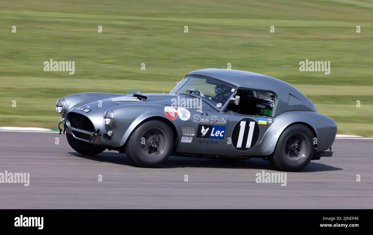 1964 AC Cobra with driver Tom Kristensen during the Graham Hill Trophy race at the 79th Members Meeting, Goodwood, Sussex, UK. Stock Photo