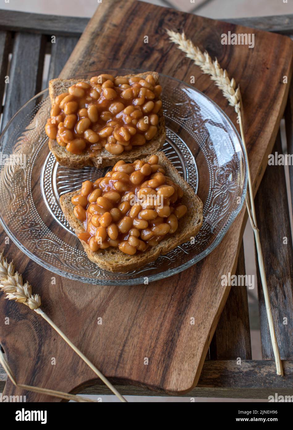 Whole wheat toast with baked beans on wooden background Stock Photo Alamy