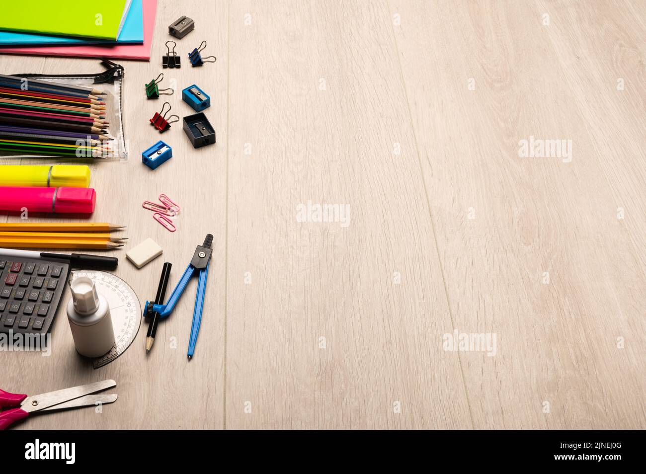 Back to school supplies,  school stationary items on a light wood background with copy space Stock Photo