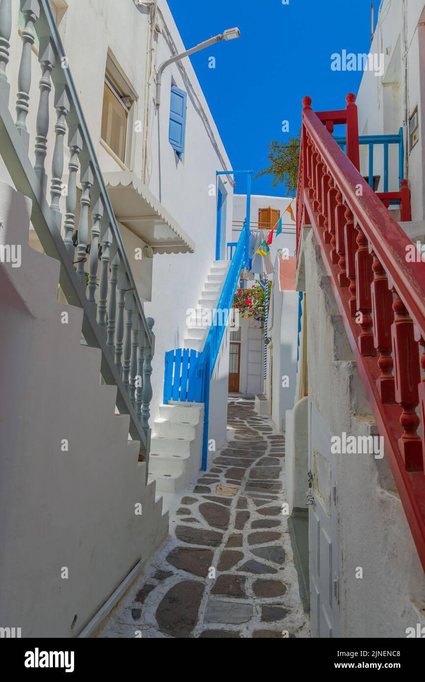 Mykonos old town in Greece: whitewashed dotted alley. Stock Photo