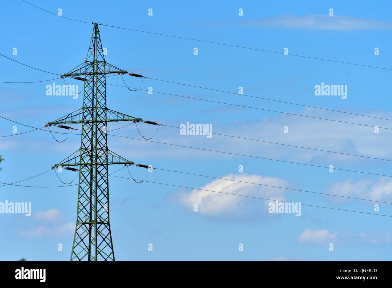 Hochspannungsmast mit Wolken und blauem Himmel - High voltage pylon with clouds and blue sky Stock Photo