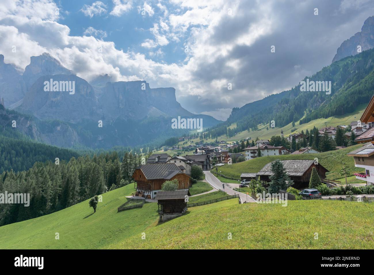 Rural houses in the field on the background of green hills Stock Photo ...