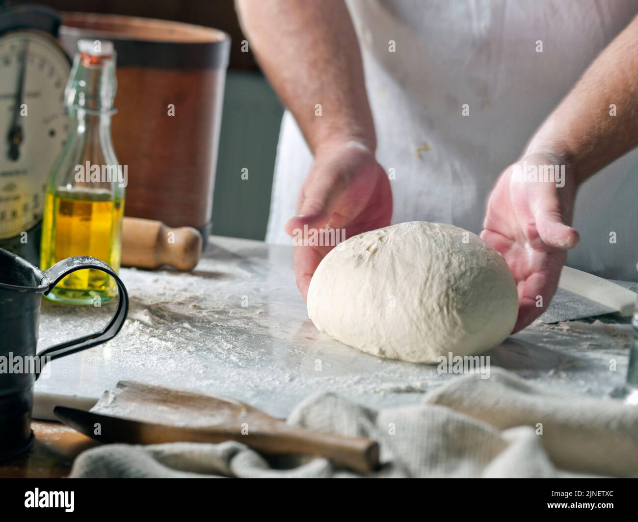 professional bread baker in bakery shop and posing with shelf with uncooked  raw bread knead on shovel. concept of traditional manual bread preparation  Stock Photo - Alamy