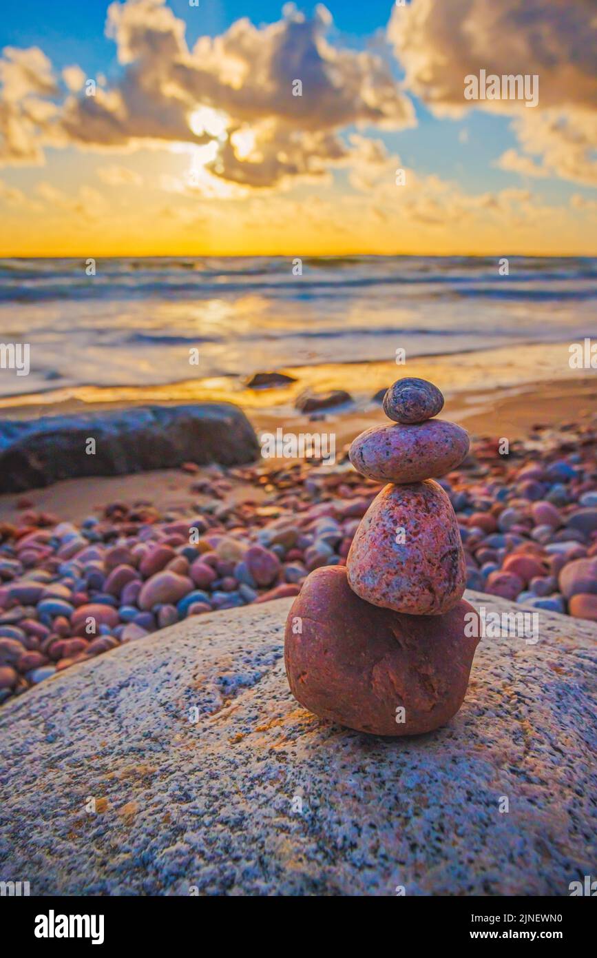 Stone tower on the beach with evening sunset light Stock Photo