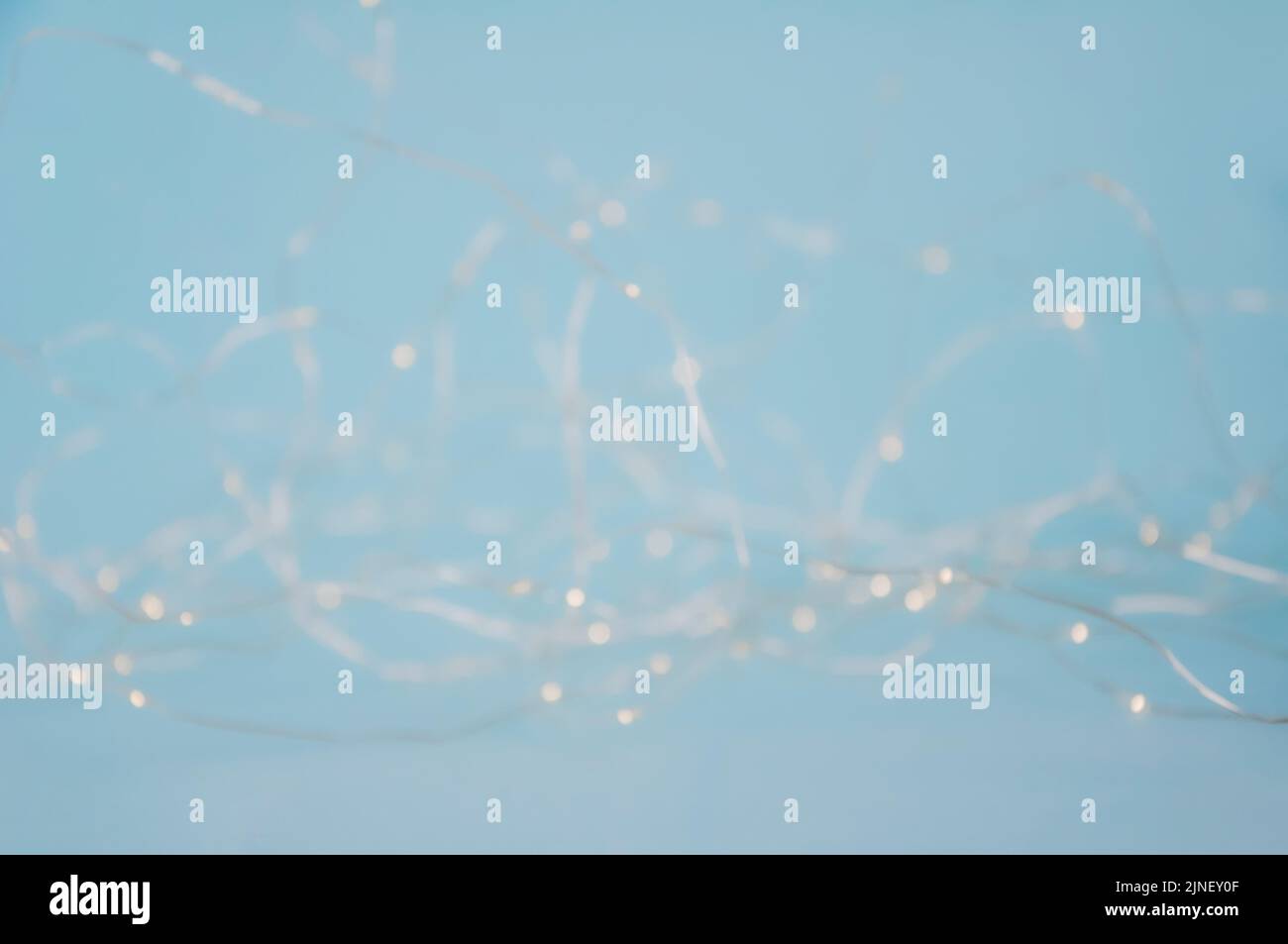 Abstract pastel blurred fairy christmas lights background. Mysterious Christmas defocused background. Festive background with twinkling bokeh stars Stock Photo