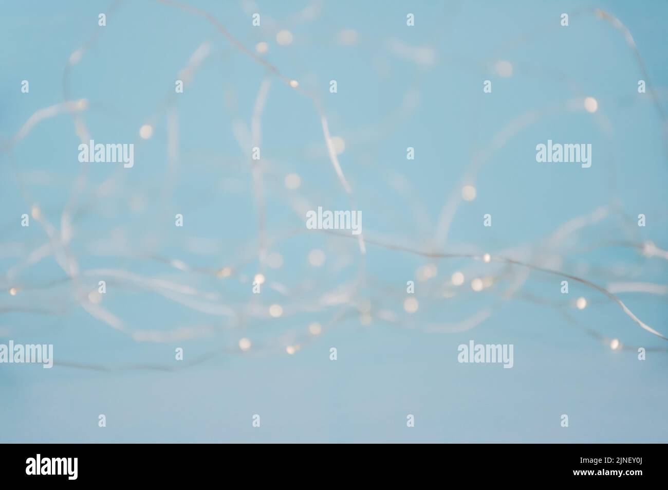 Abstract pastel blurred fairy christmas lights background. Mysterious Christmas defocused background. Festive background with twinkling bokeh stars Stock Photo