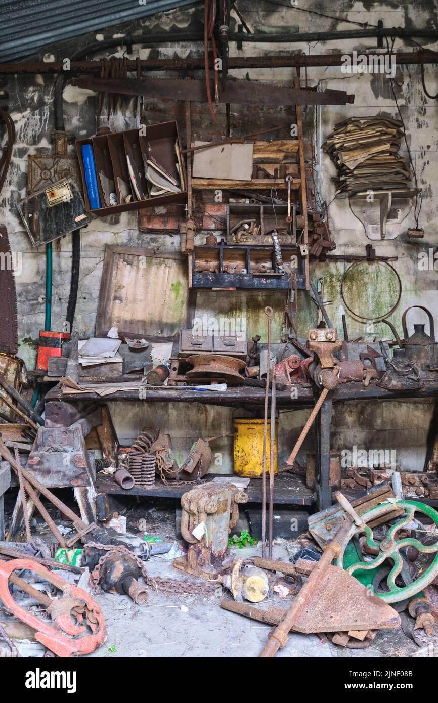 View of a classic, iconic, typical, generic, messy, gross tool shed full of old, rusty items. At the Big Pit National Coal Museum in Pontypool, Wales, Stock Photo