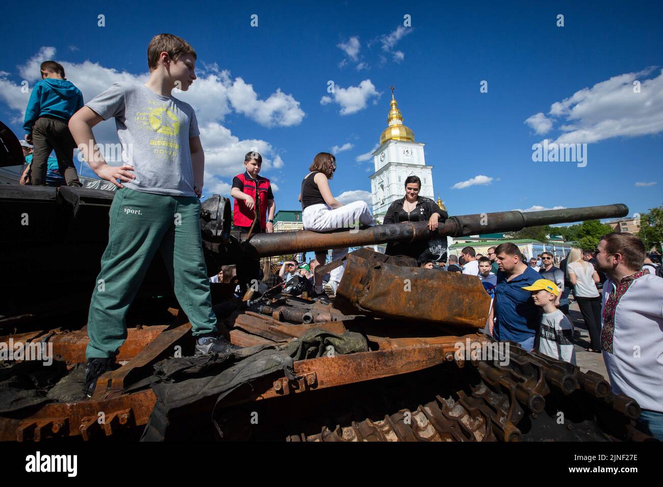 Children play on a destroyed Russian tank during an exhibition showing Russian military hardware destroyed during Russia's invasion of Ukraine in central Kyiv. On February 24, 2022, Russian troops entered Ukrainian territory, starting a conflict that provoked destruction and a humanitarian crisis. Stock Photo