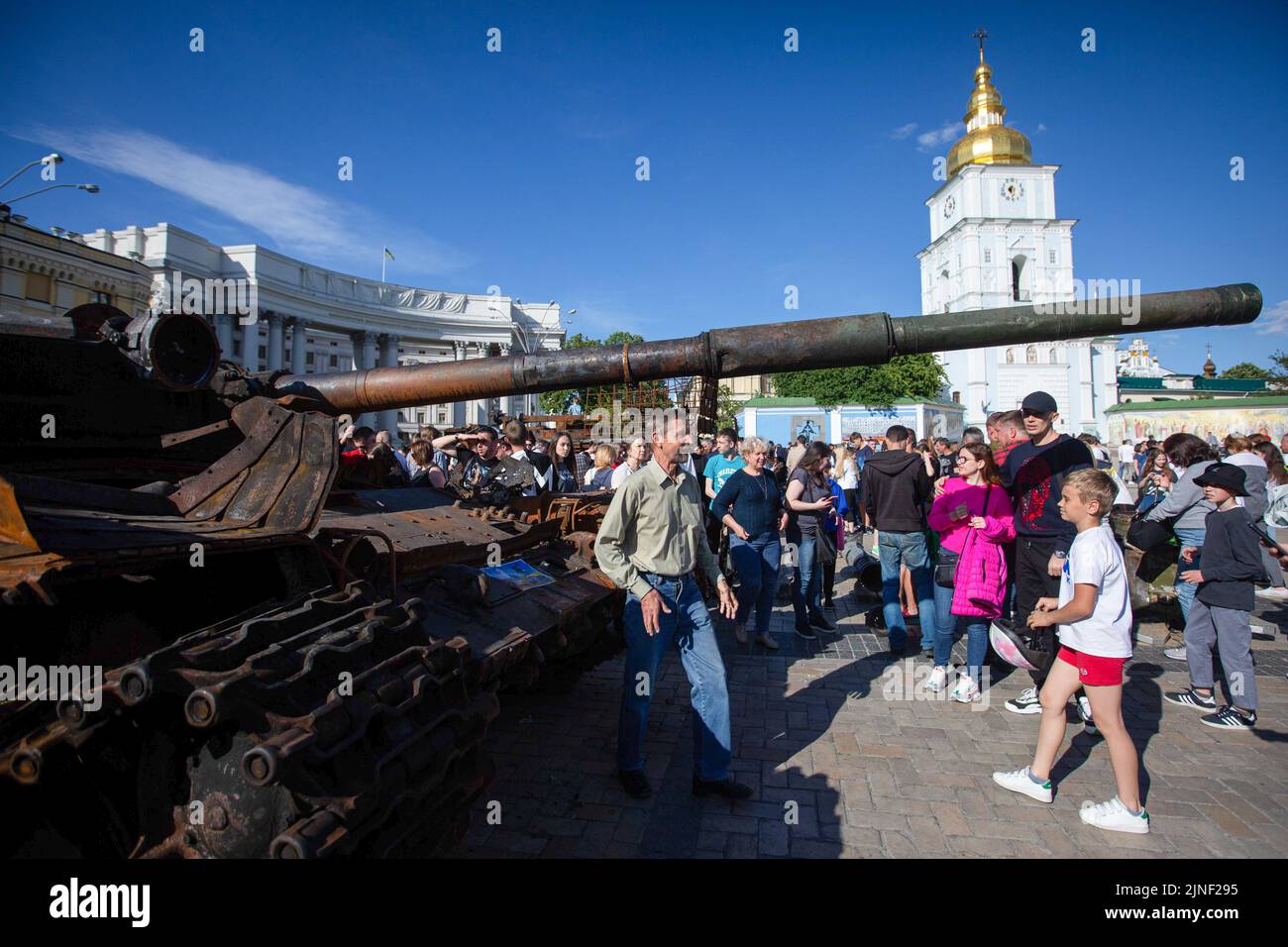 People look at the destroyed Russian tank during an exhibition showing Russian military hardware destroyed during Russia's invasion of Ukraine in central Kyiv. On February 24, 2022, Russian troops entered Ukrainian territory, starting a conflict that provoked destruction and a humanitarian crisis. Stock Photo