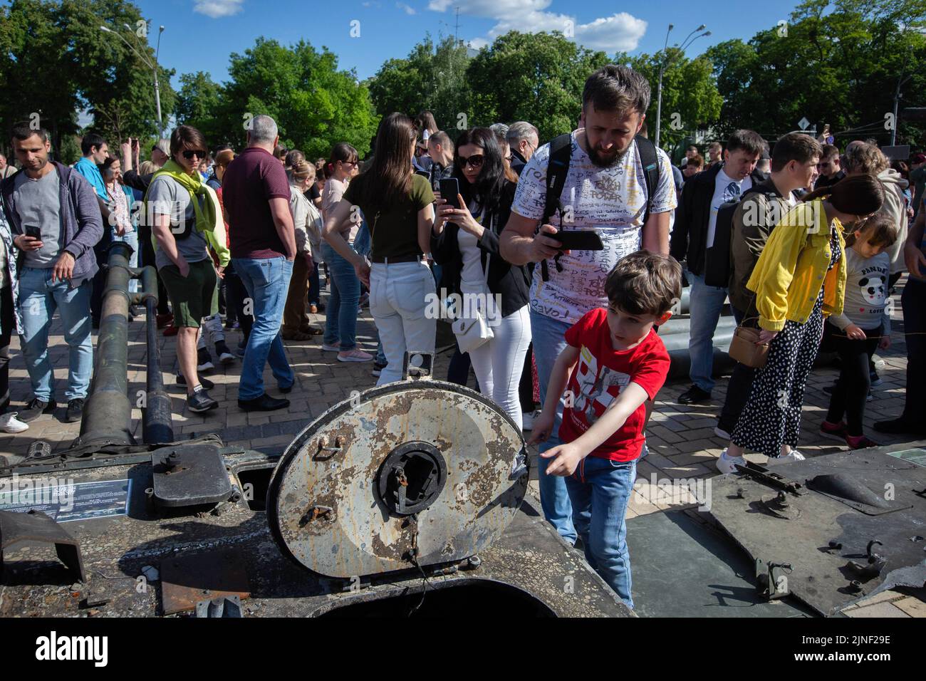 People look at fragments of a destroyed Russian tank during an exhibition showing Russian military hardware destroyed during Russia's invasion of Ukraine in central Kyiv. On February 24, 2022, Russian troops entered Ukrainian territory, starting a conflict that provoked destruction and a humanitarian crisis. Stock Photo