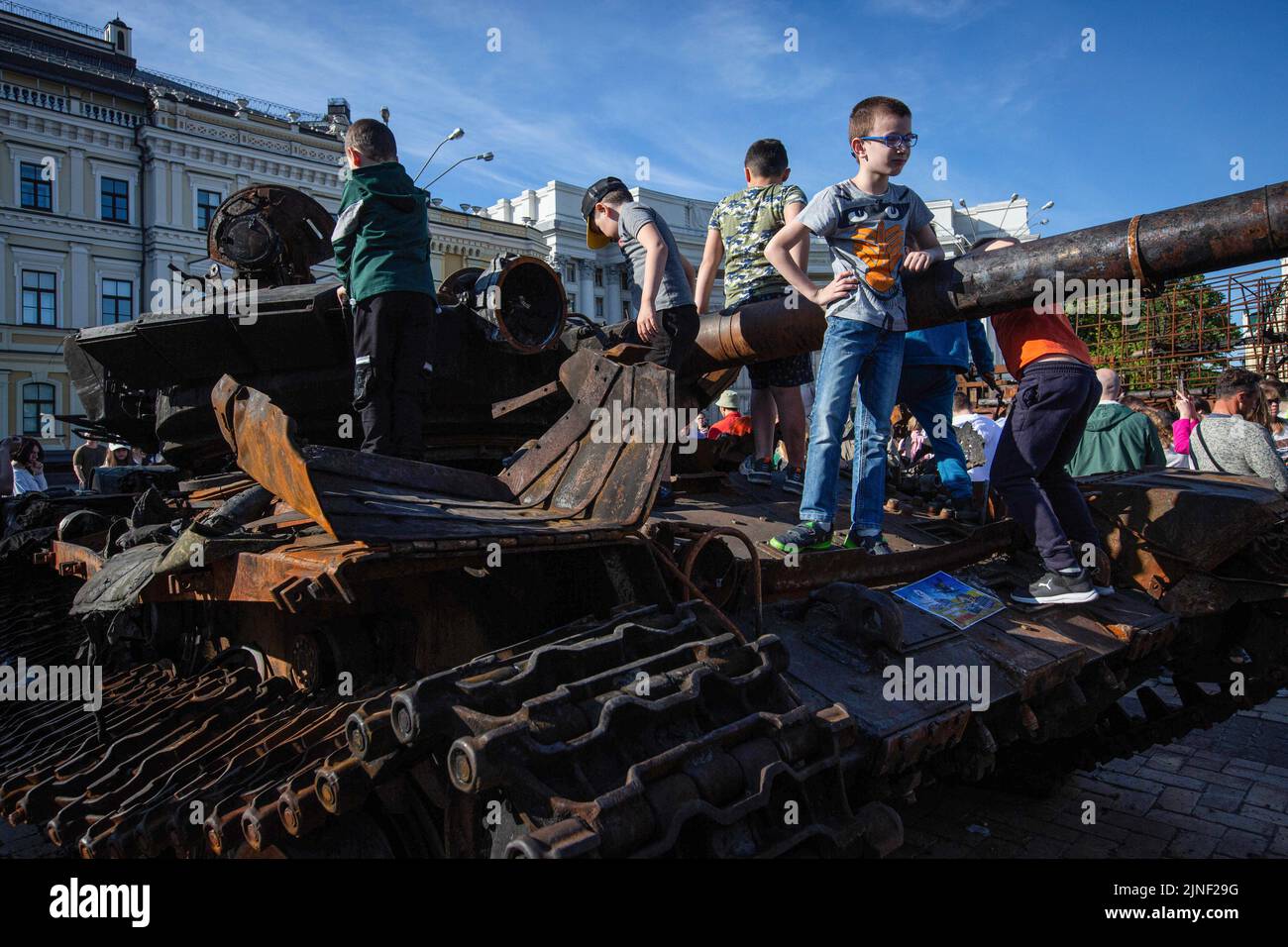 Children play on a destroyed Russian tank during an exhibition showing Russian military hardware destroyed during Russia's invasion of Ukraine in central Kyiv. On February 24, 2022, Russian troops entered Ukrainian territory, starting a conflict that provoked destruction and a humanitarian crisis. Stock Photo