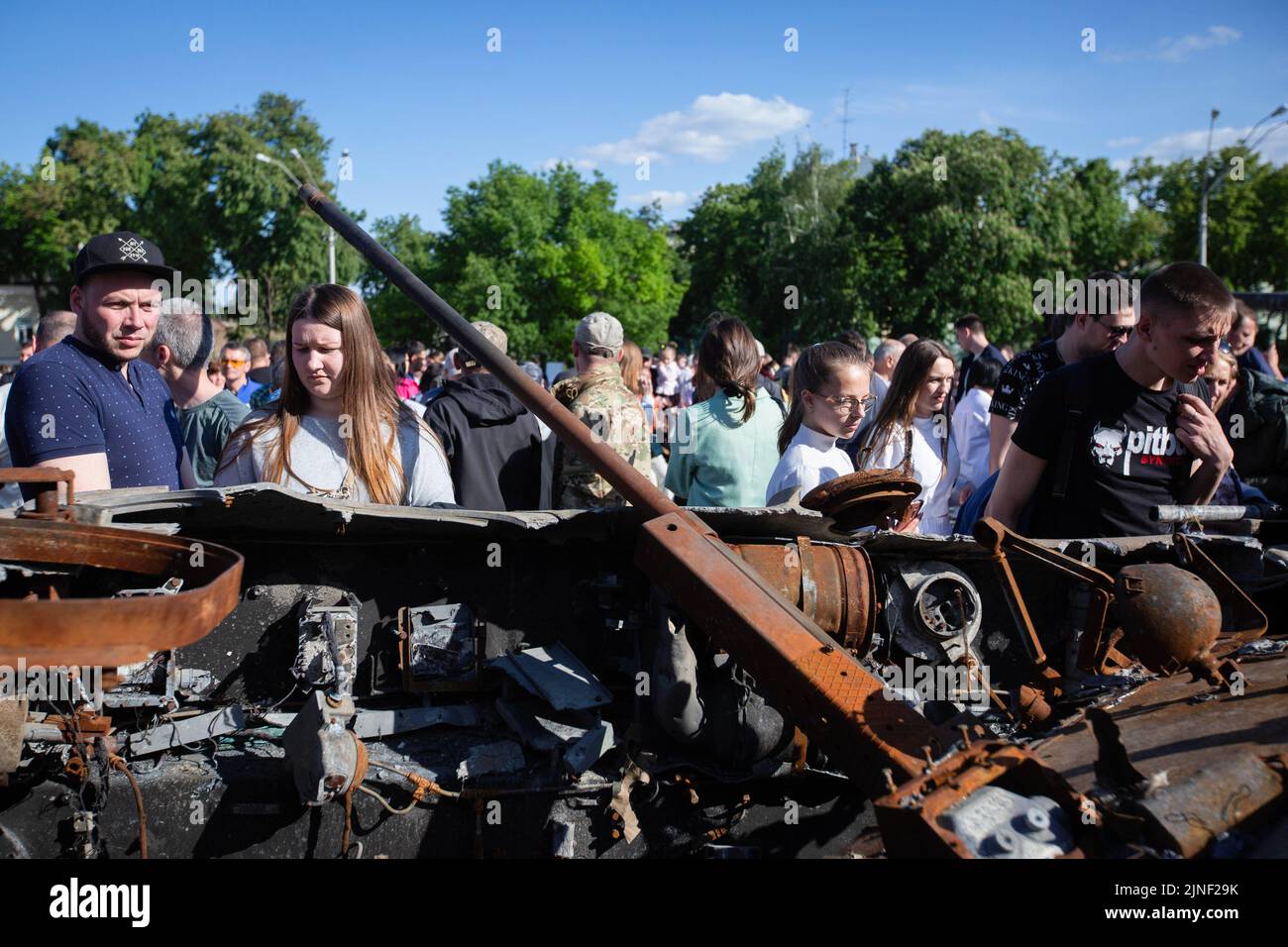 People look at a burnt Russian armored personnel carrier during an exhibition showing Russian military hardware destroyed during Russia's invasion of Ukraine in central Kyiv. On February 24, 2022, Russian troops entered Ukrainian territory, starting a conflict that provoked destruction and a humanitarian crisis. Stock Photo
