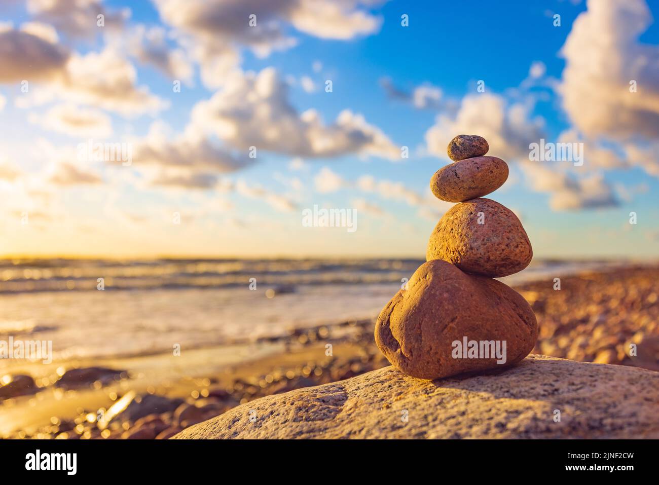 Stone tower on the beach with evening sunset light Stock Photo