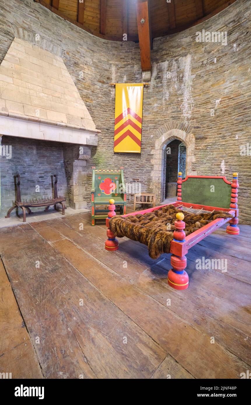 A room furnished with colorful, garish, cartoony fake period furniture and banners. At Caerphilly Castle in Caerphilly, United Kingdom. Stock Photo