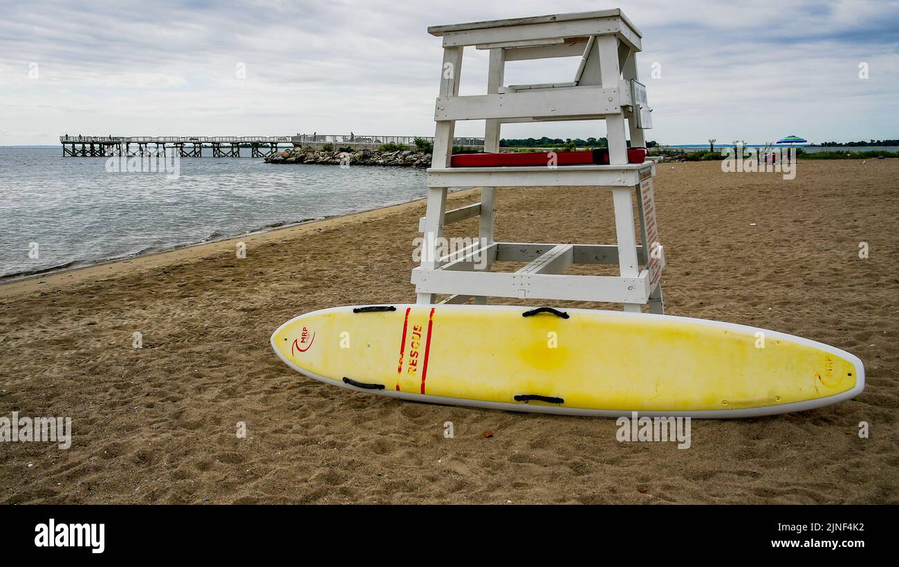 NORWALK, CT USA - AUGUST 10, 2022: Lifeguard chair and  fishing pier on  Calf Pasture beach in summer day panorama with copy space Stock Photo