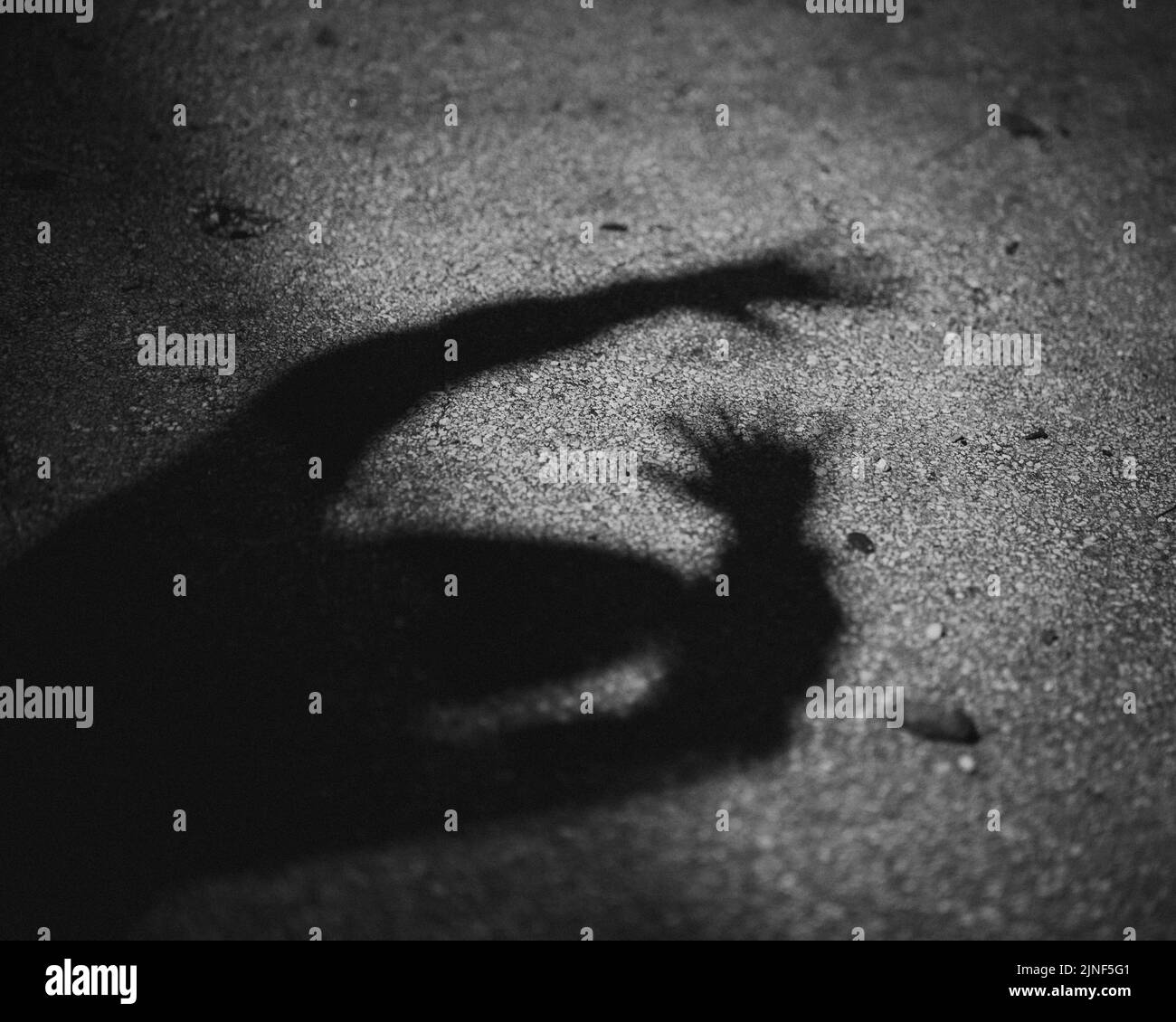 A scary silhouette of a man on the ground Stock Photo - Alamy