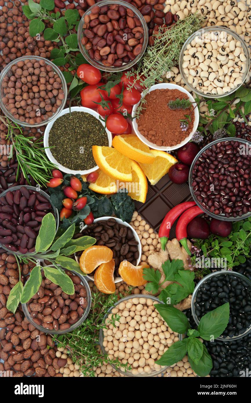 Healthy vegan food high in flavonoids and polyphenols. Legumes, herbs, fruit, vegetables, coffee, tea, cacao powder. Stock Photo