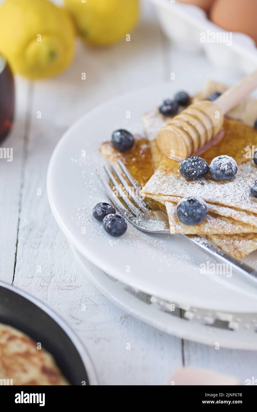 Freshly prepared crepes with blueberries - shallow dof Stock Photo
