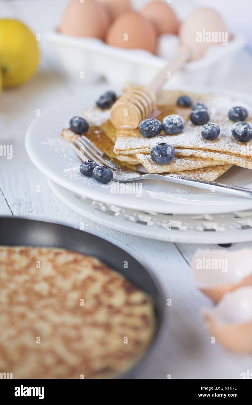 Freshly prepared crepes with blueberries - shallow dof Stock Photo