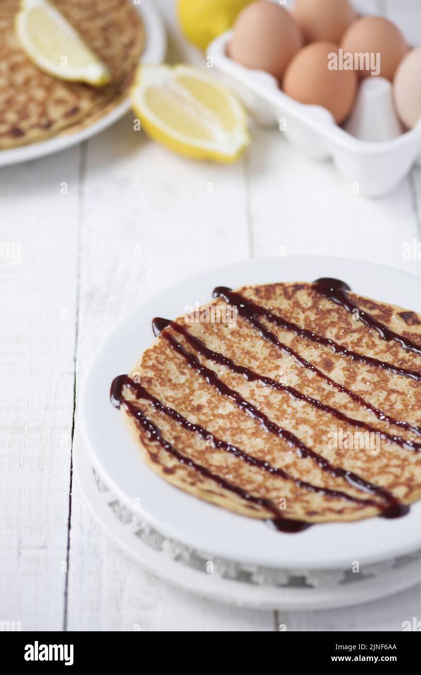 Freshly prepared crepes with chocolate sauce - shallow dof Stock Photo