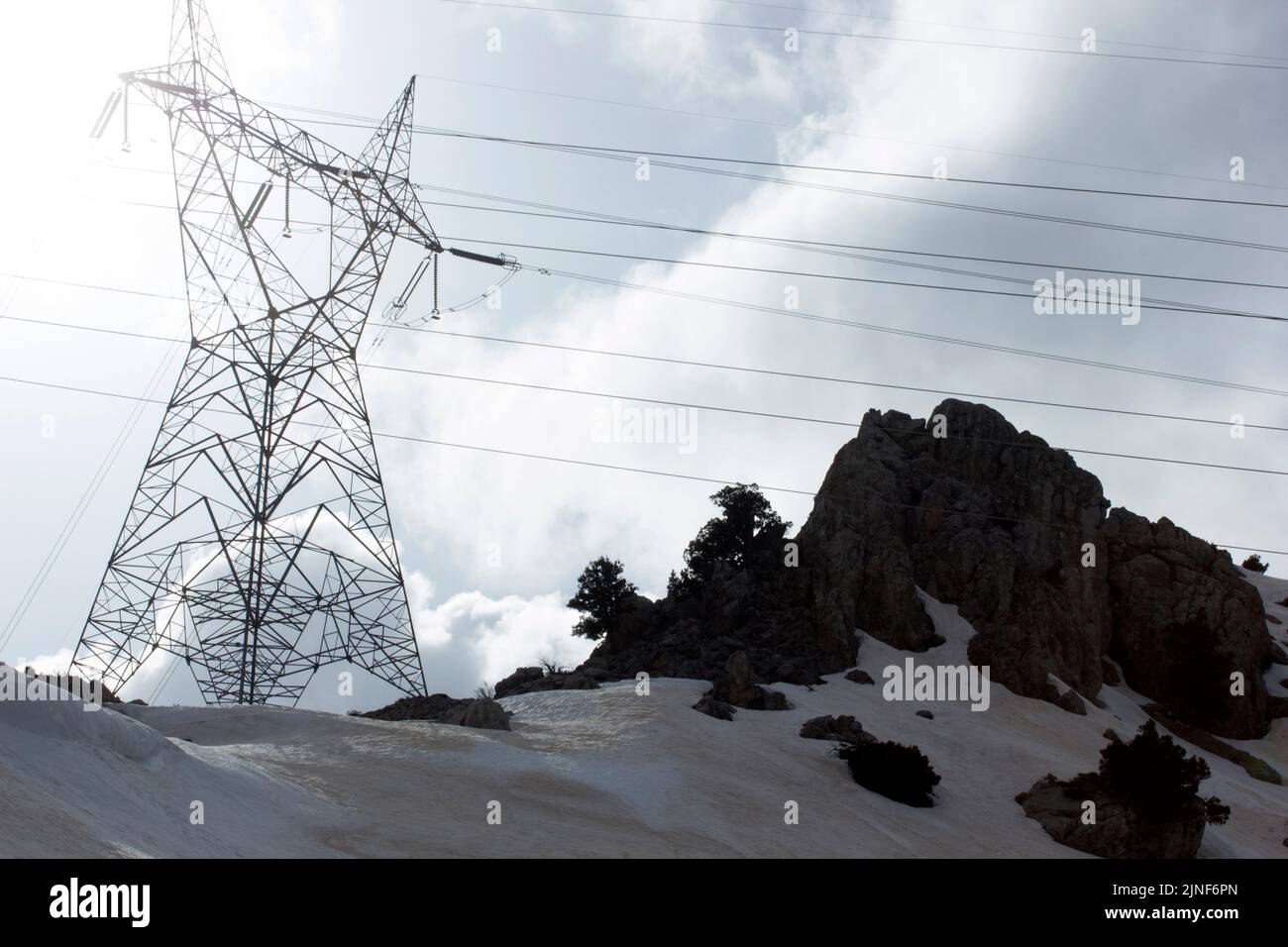 High voltage electricity pylon under snow landscape Stock Photo - Alamy