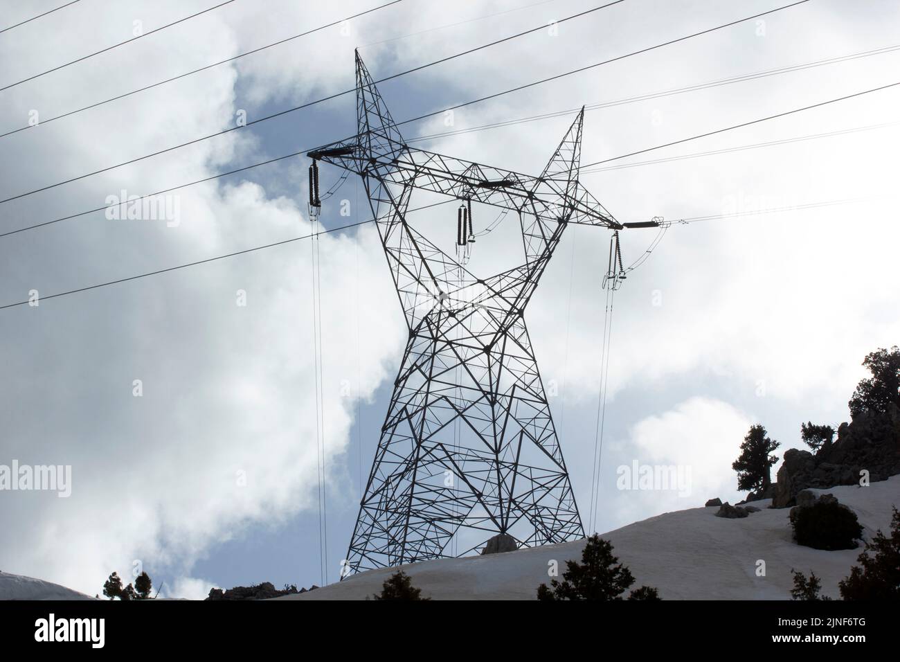High voltage electricity pylon under snow landscape Stock Photo - Alamy