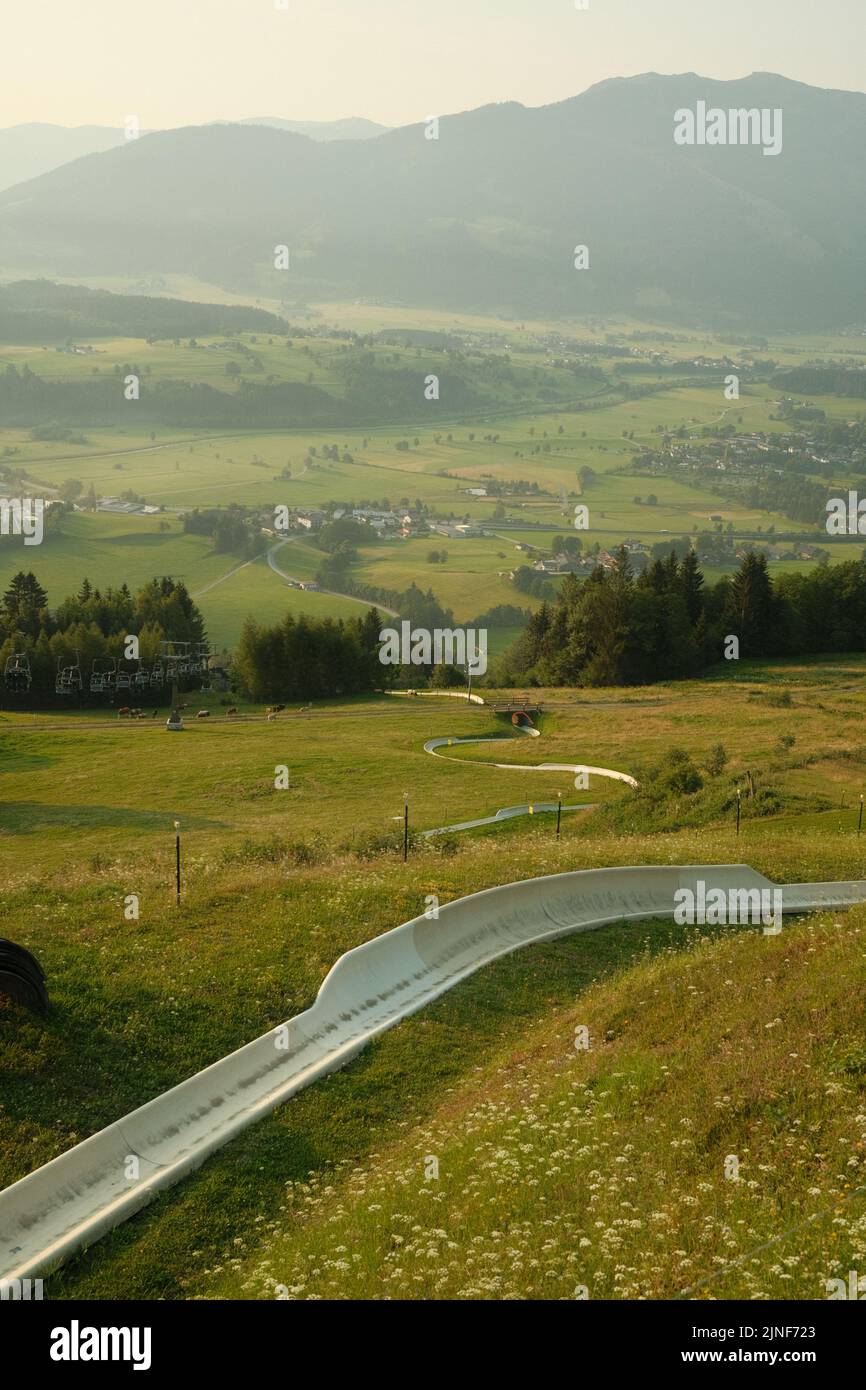 A vertical shot of summer toboggan with the view of green vale. Biberg