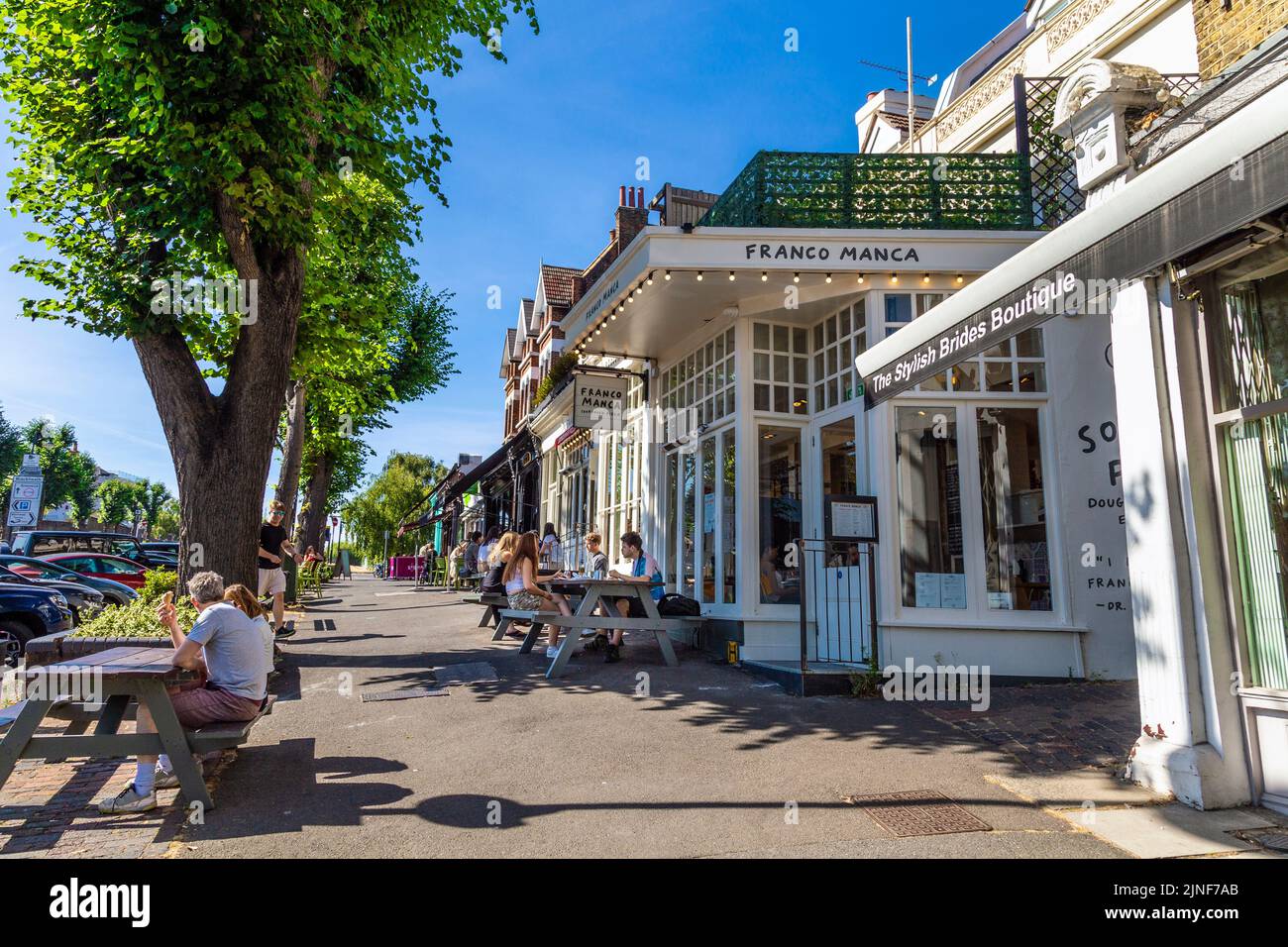 People dining outdoors on a sunny day in Blackheath, London, UK Stock Photo