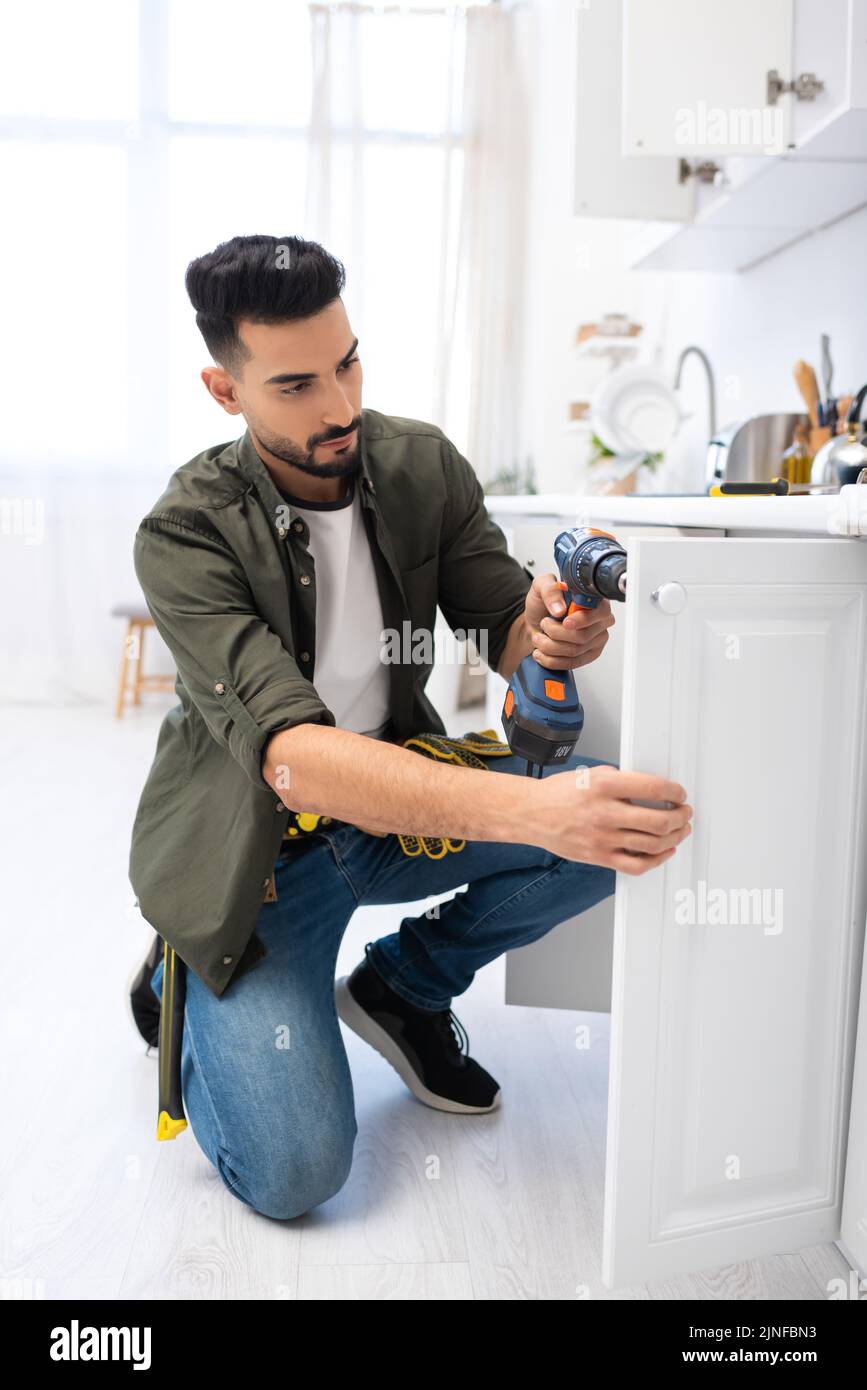 Bearded young man fixing hi-res stock photography and images - Alamy