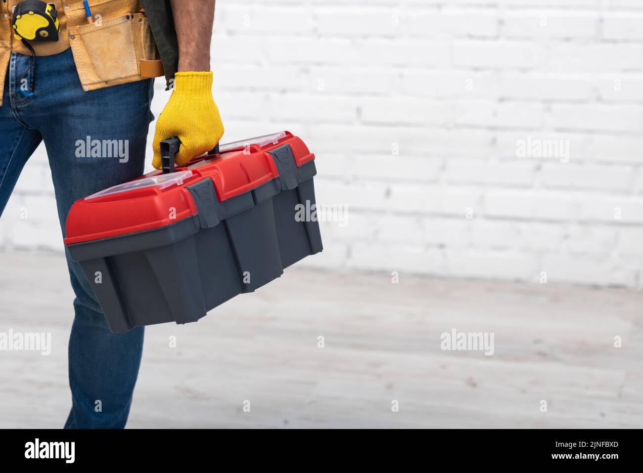 Partial view of repairman holding toolbox at home,stock image Stock Photo