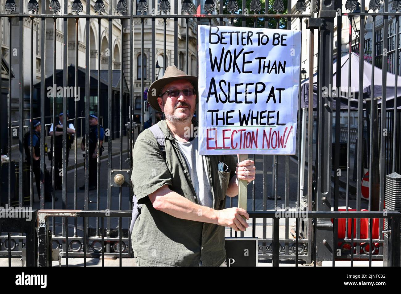 London, UK. A lone protester braved the heat to call out the Government who appear to be asleep at the wheel during this challenging time. Downing Street Gates, Whitehall. Credit: michael melia/Alamy Live News Stock Photo