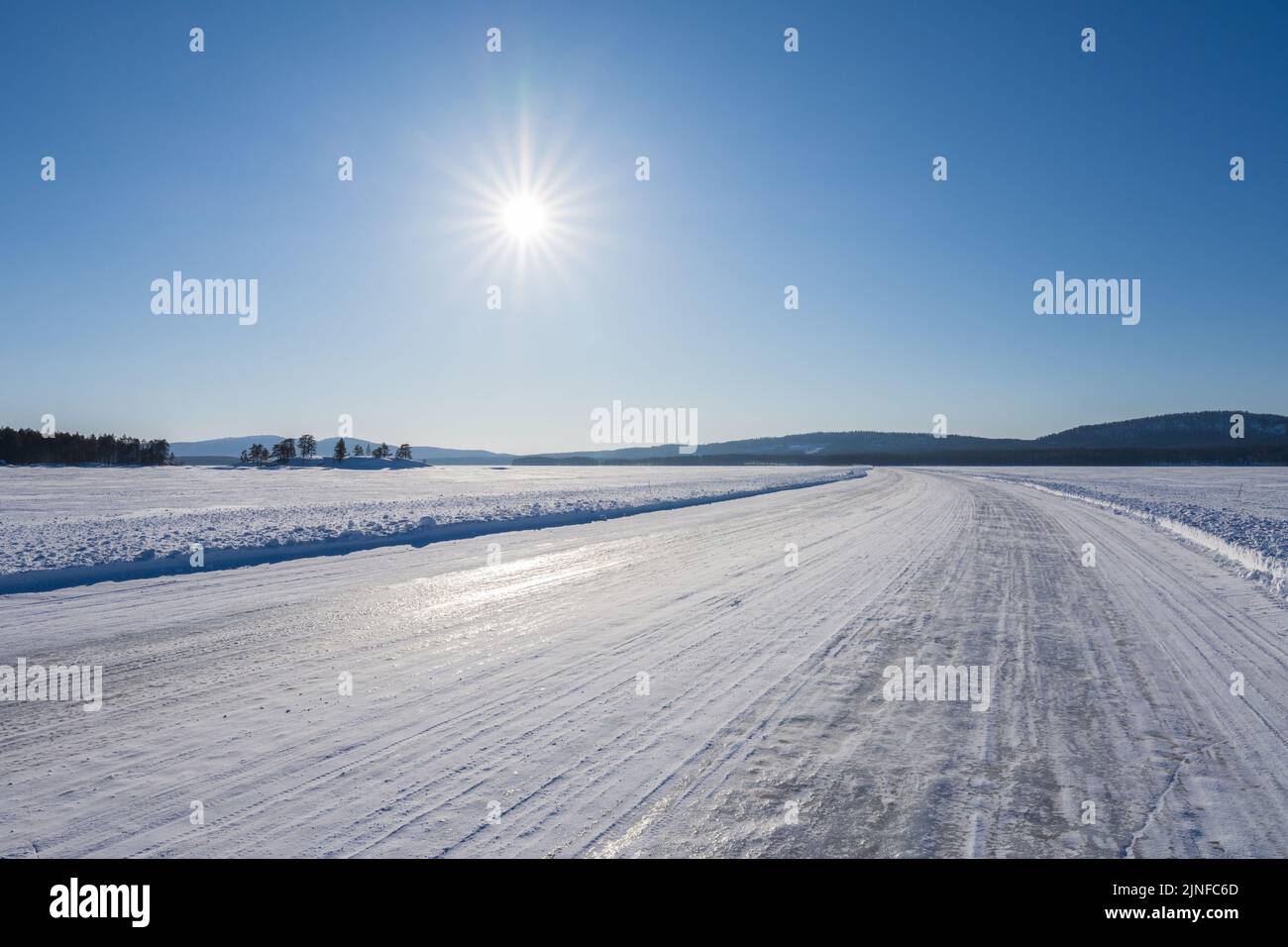 Ice road over Lake Pielinen in Eastern Finland. The longest official ice road in Europe’s inland waterways. Stock Photo