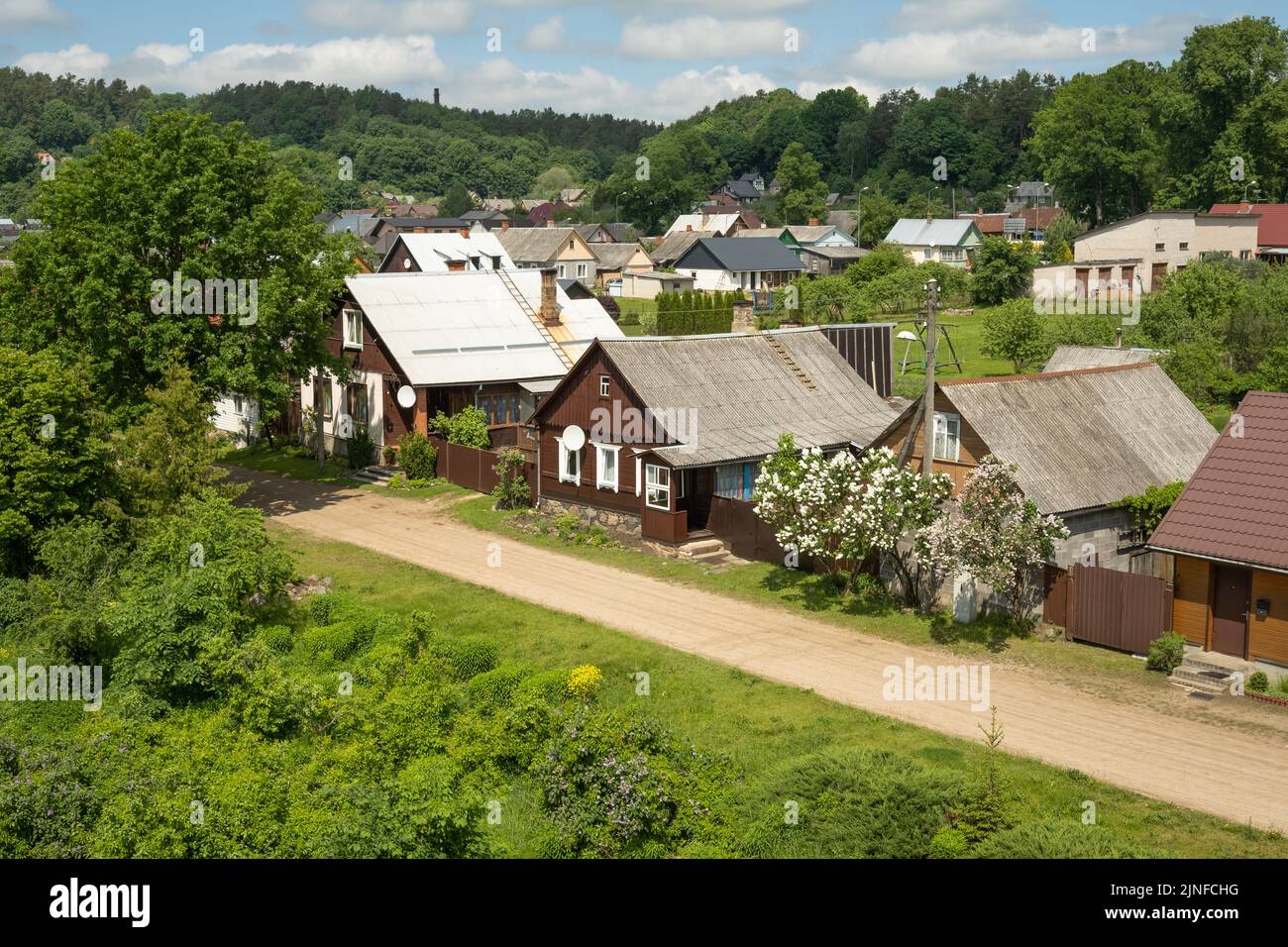 Old wooden living houses near riverside in Kraslava Stock Photo