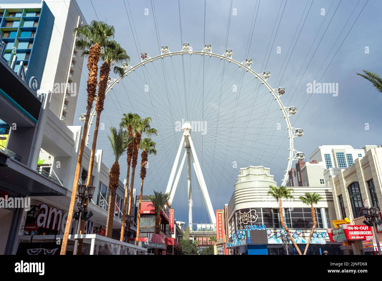 Enjoy stunning views of The High Roller Observation Wheel at The LINQ Promenade in Las Vegas. Experience the thrill of this iconic attraction today! Stock Photo