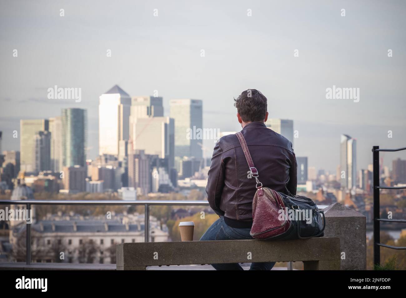 Back view of a man enjoying the view of London cityscape from Greenwich hill Stock Photo
