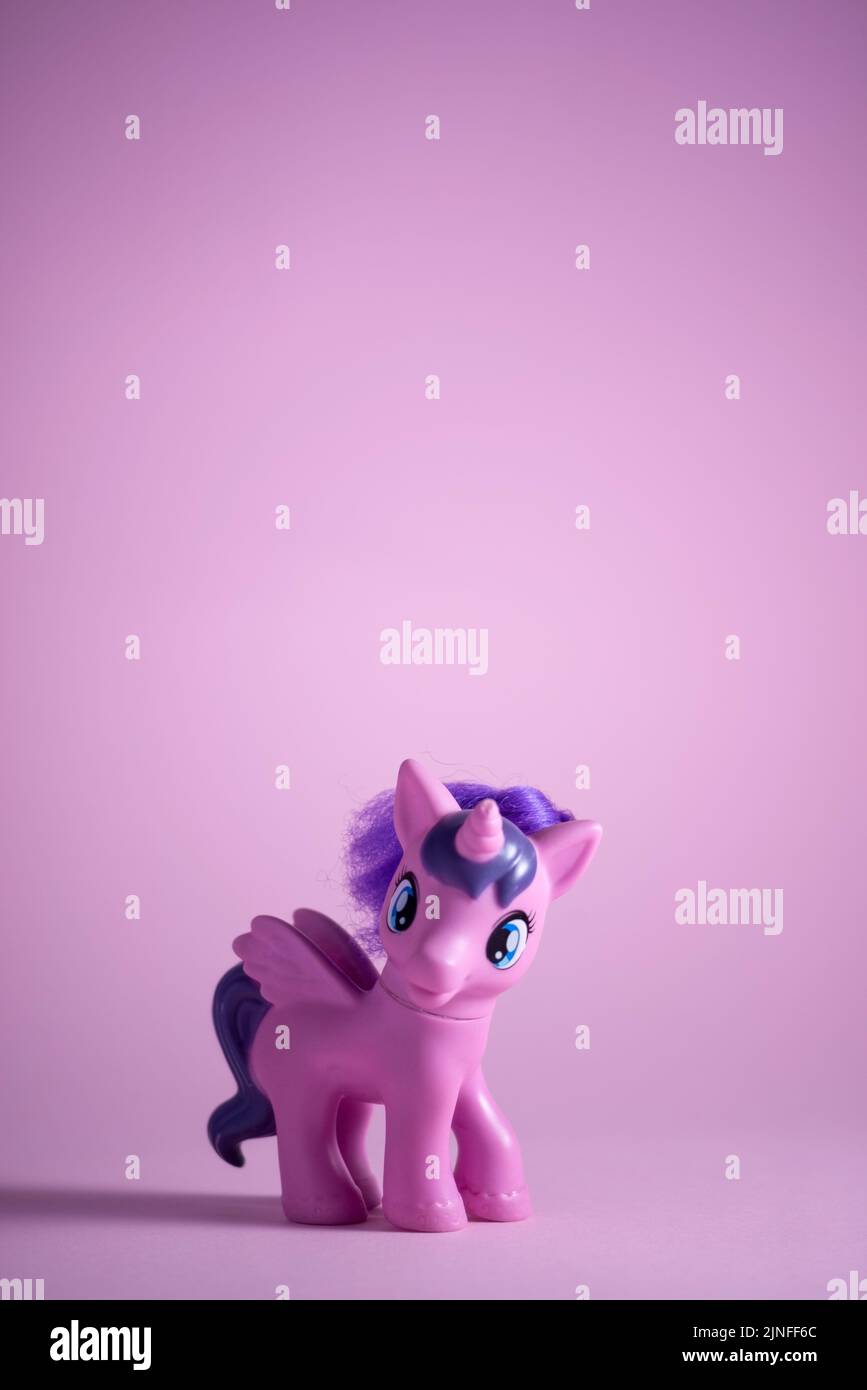 toy pink unicorn pony on a pink background. Stock Photo