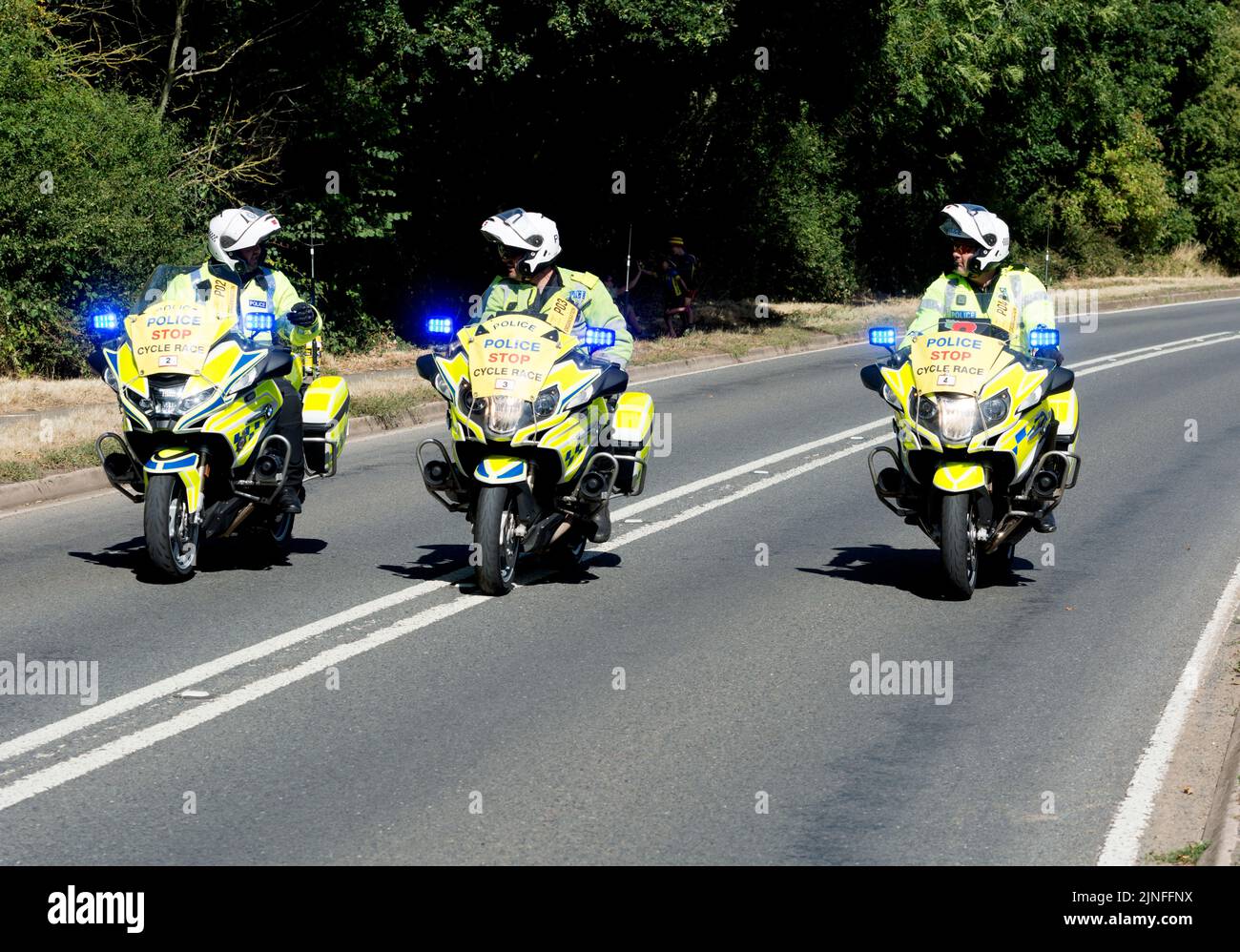 Police BMW motorcycles for the 2022 Commonwealth Games cycling road race, Hampton Road, Warwick, Warwickshire, UK Stock Photo