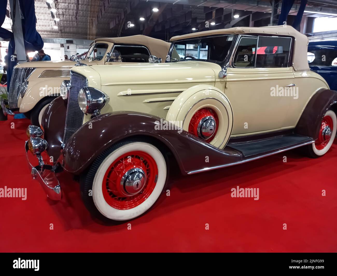 Old vintage beige brown 1934 Chevrolet Chevy Master coupe cabriolet by GM on a red carpet. Classic car show Stock Photo