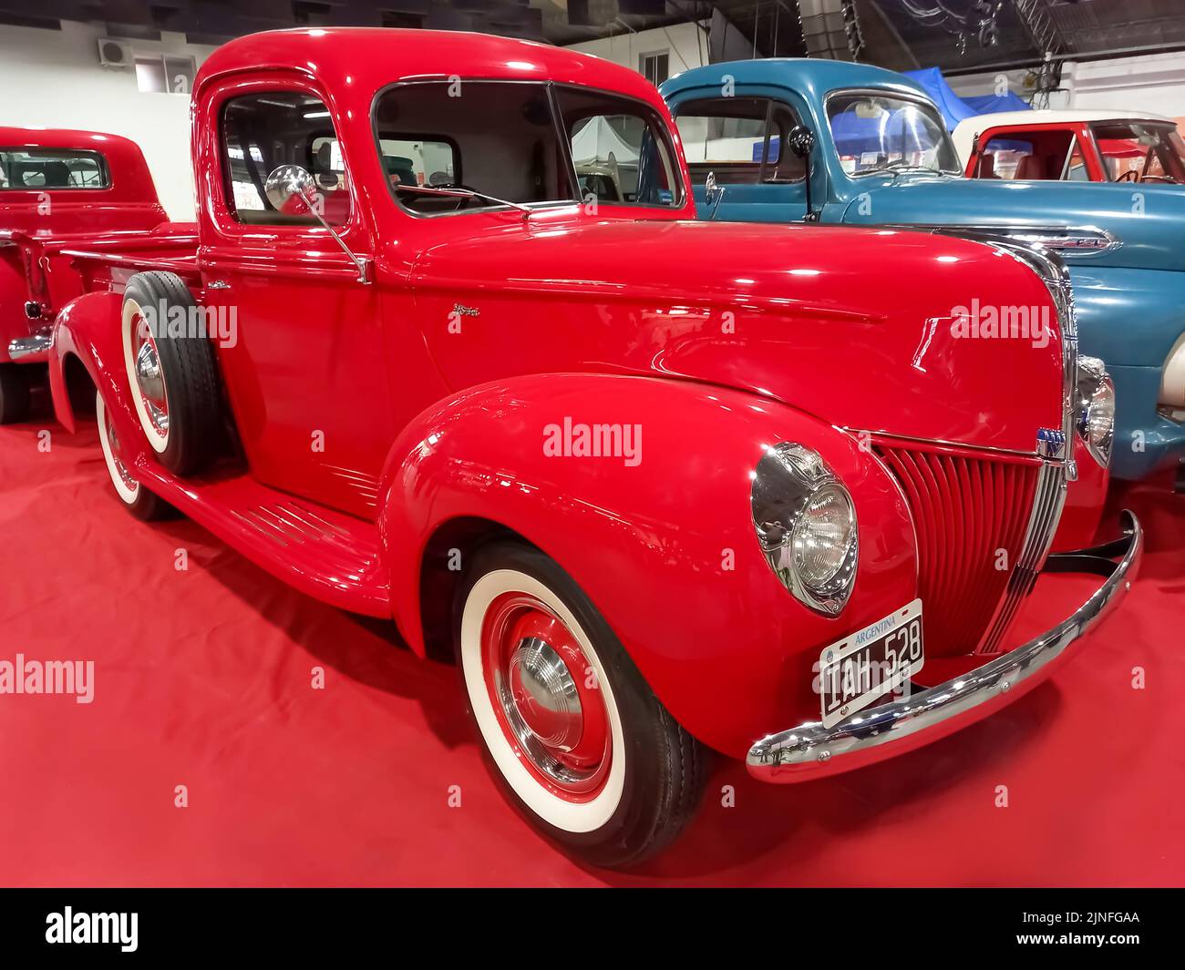 Old vintage red 1940 Ford V8 model 83 utility pickup truck on the carpet. Exhibit hall. Classic car show. Stock Photo