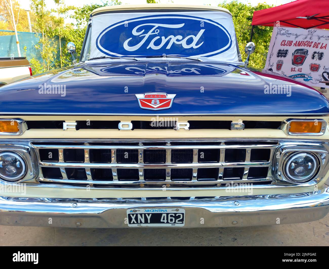Ford blue oval logo and brand on the windshield of an old F100 V8 utility pickup truck 1963. Front View. Expo Fierros 2022 classic car show Stock Photo