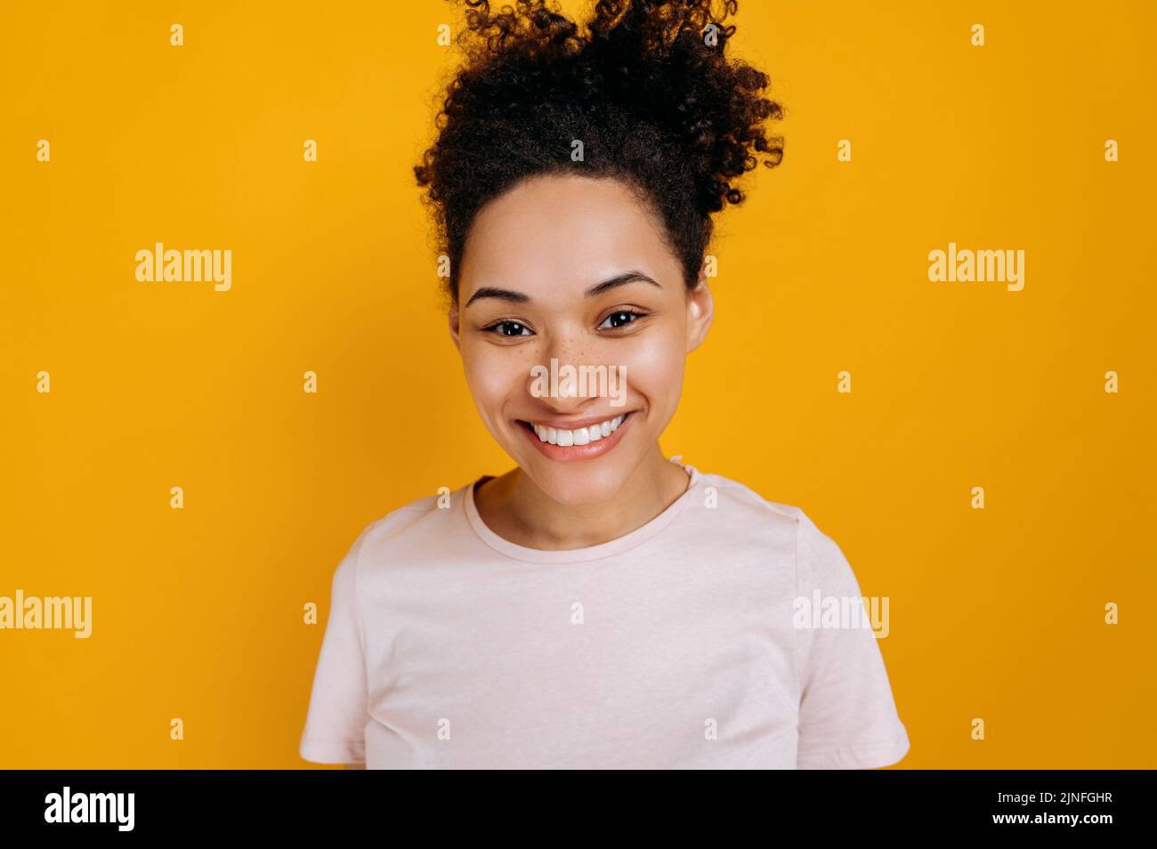 Close-up photo of happy african american young woman with curly hair ...