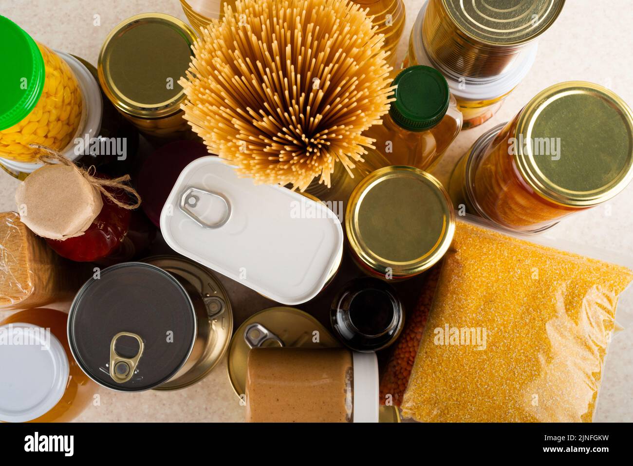 Emergency survival food set on white kitchen table high angle view Stock Photo