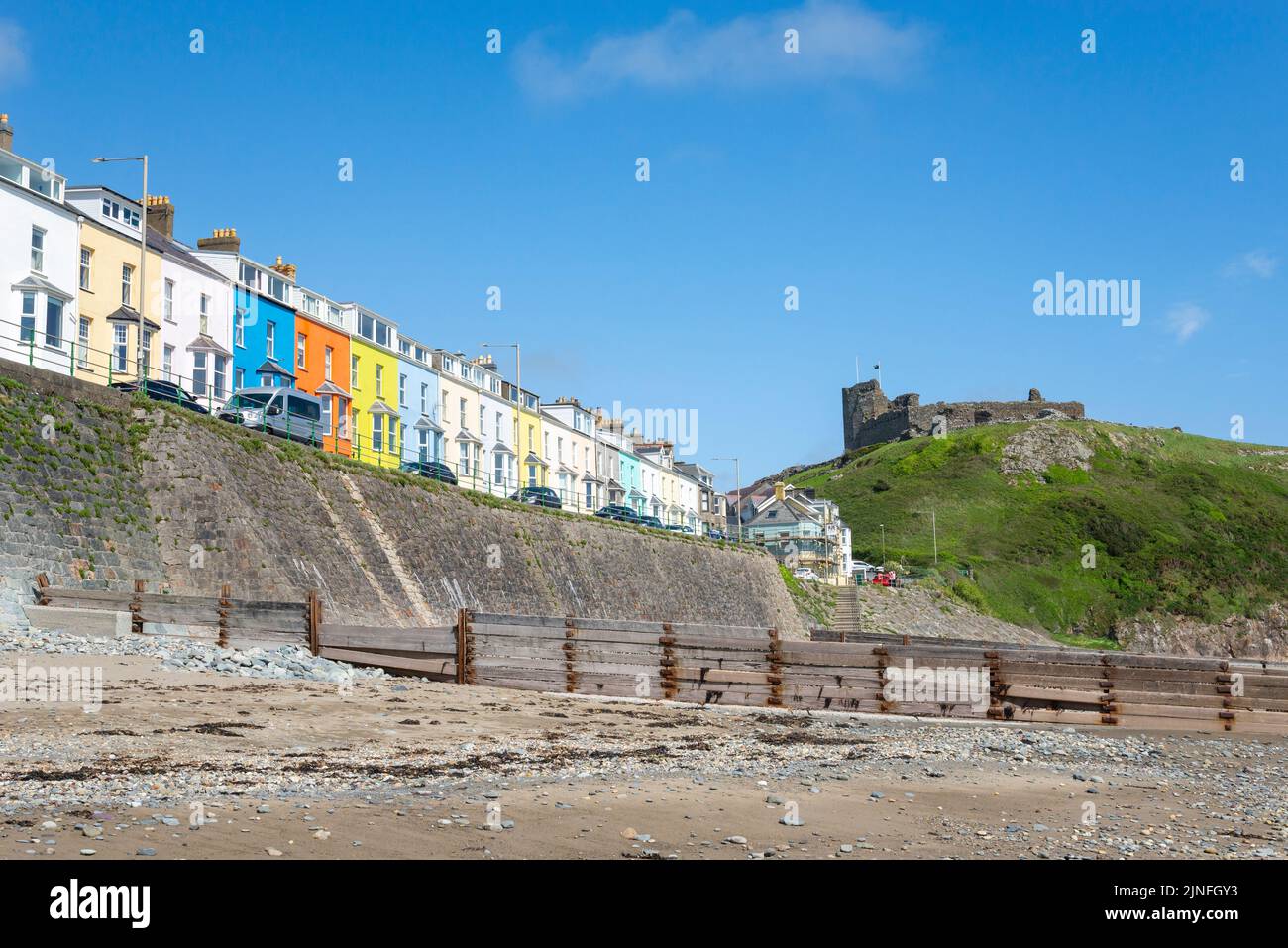 Criccieth castle and marine terrace seen from the beach on the coast of Gwynedd, North Wales. Stock Photo