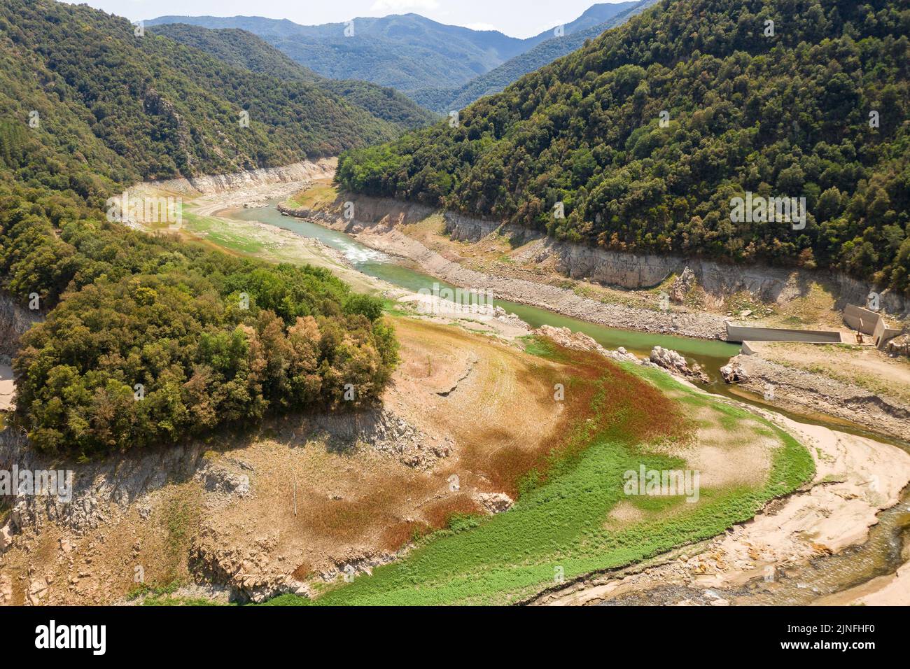 Dry tail meander of the Susqueda reservoir during the summer drought of 2022 (La Selva, Girona, Catalonia, Spain) ESP: Meandro del embalse de Susqueda Stock Photo
