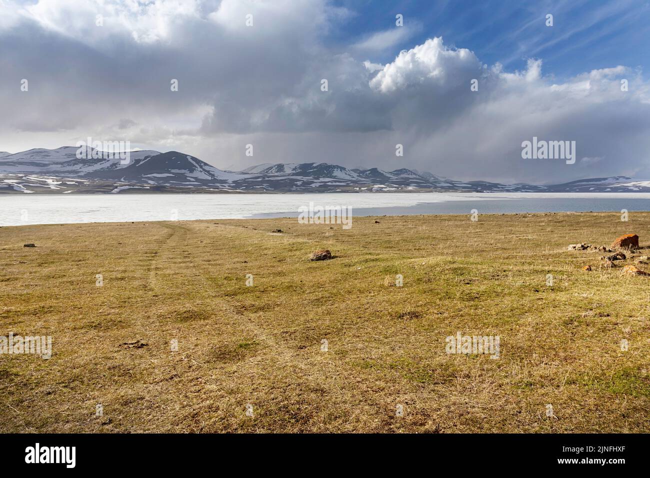 Beautiful and frozen lake Paravani and snowy mountains in the ...
